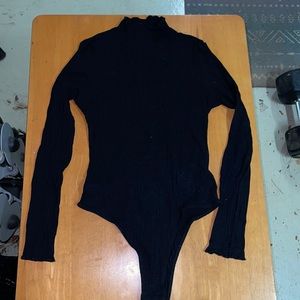 This is a black body suit. Also a turtle neck
